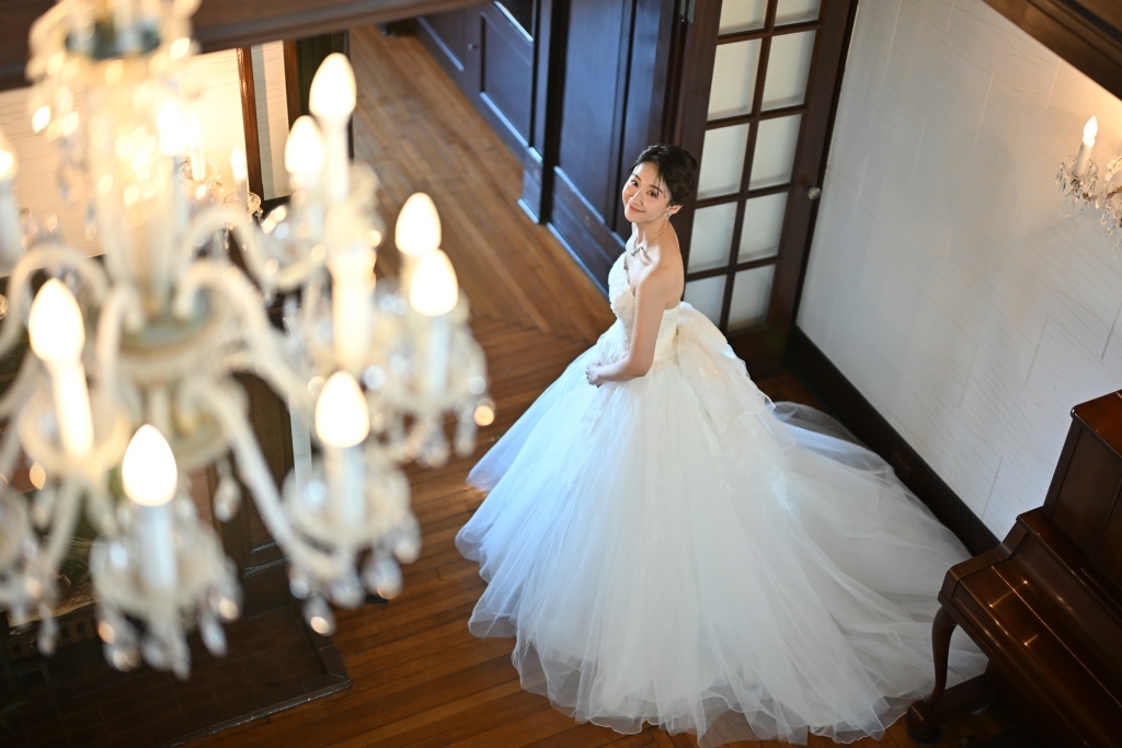 ウェディングドレスでポーズを取る花嫁の全身写真